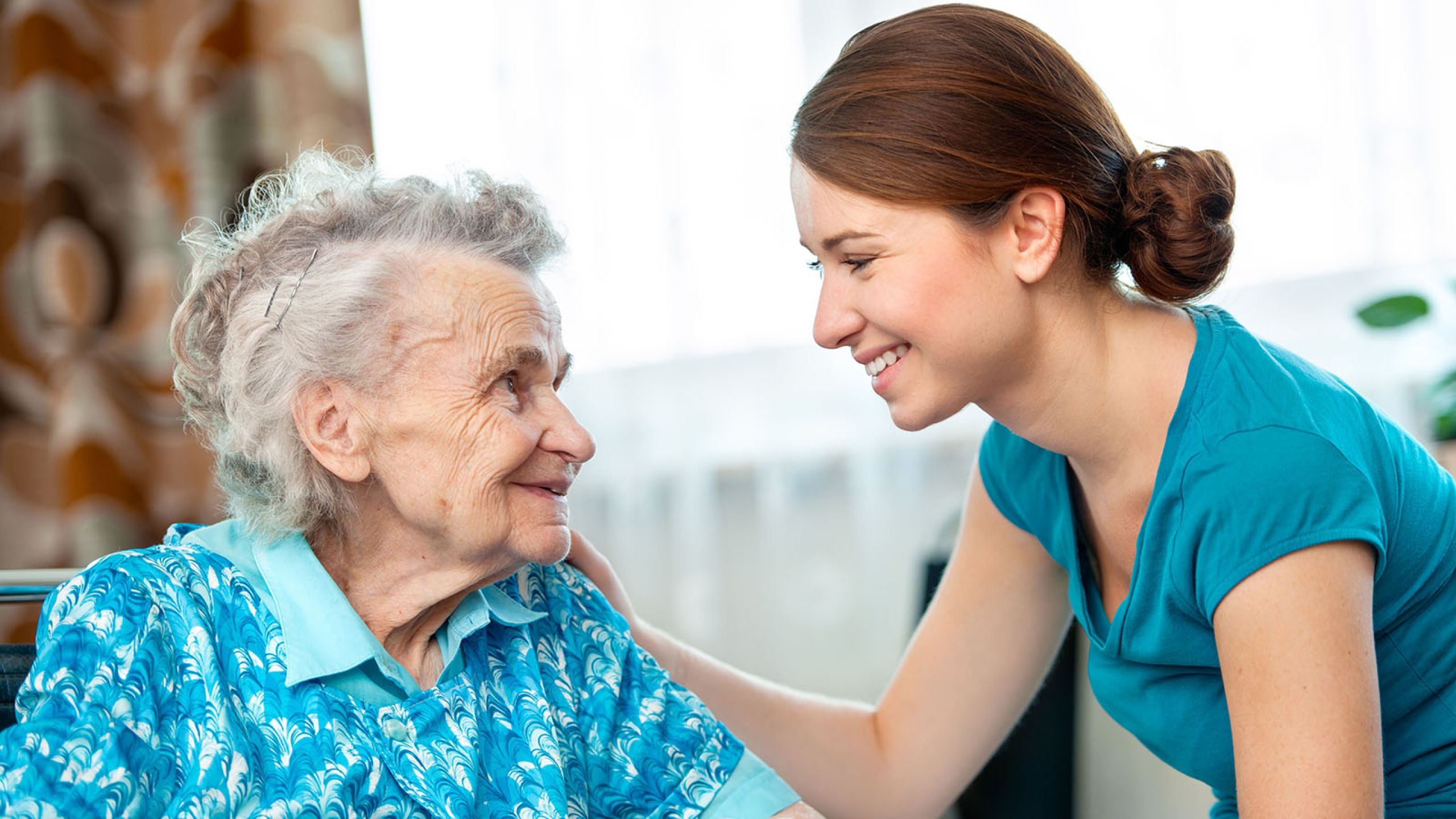 Young woman assisting assisting and elderly woman