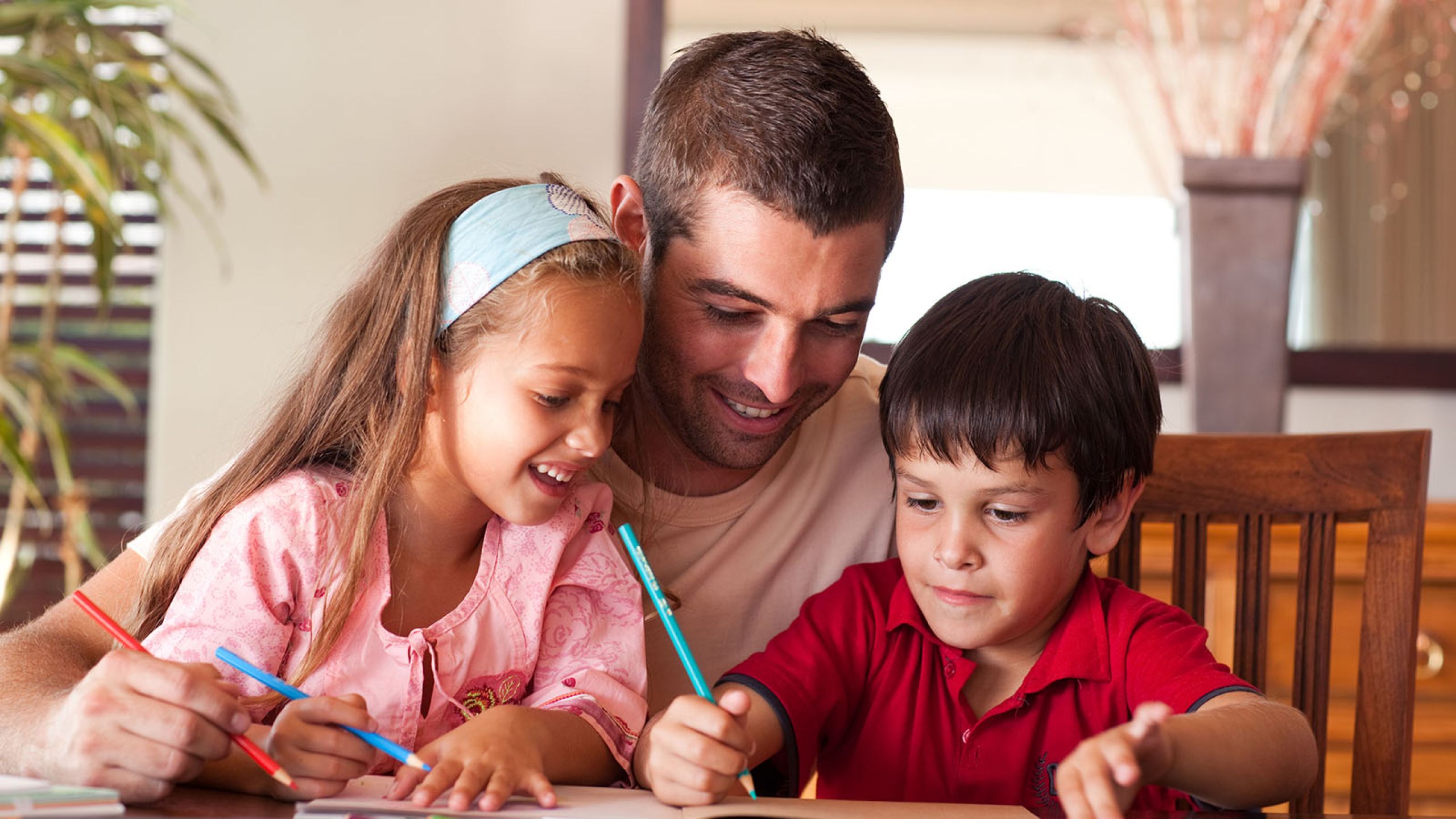 Man helping children with school work